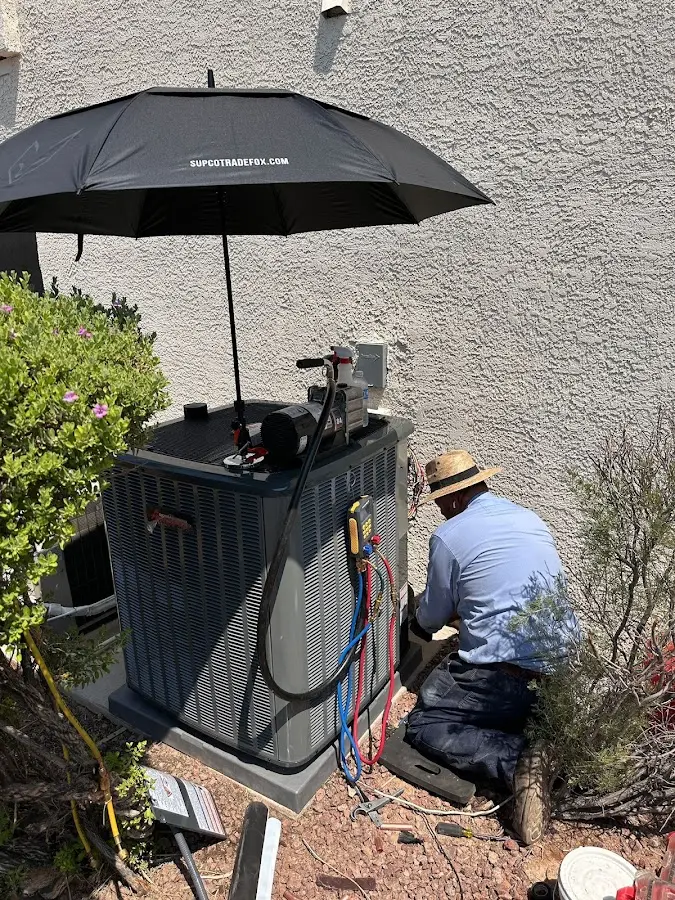 HVAC technician performing outdoor AC maintenance in Schuyler Falls